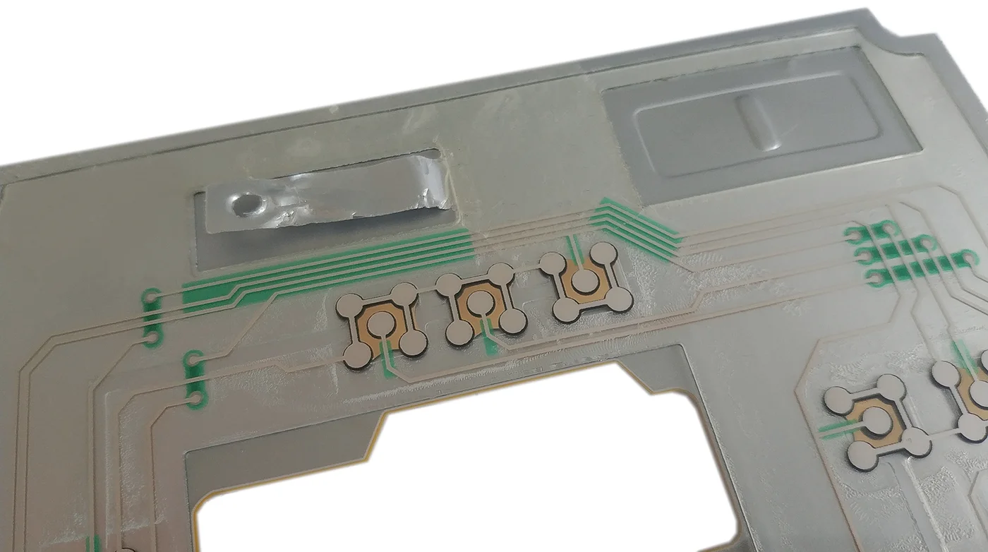 This is a shielded membrane switch solution that uses aluminum foil as a shielding ground.